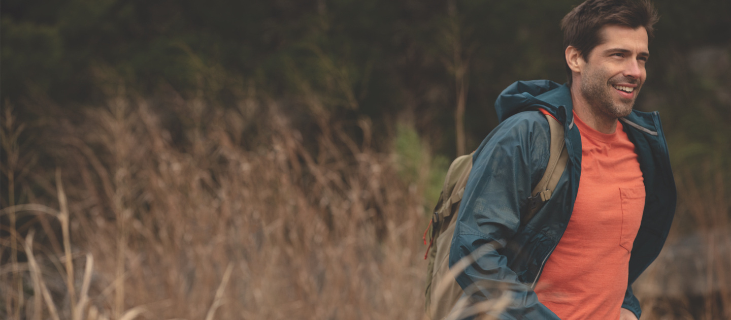 man hiking in a field
