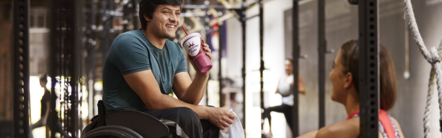 athlete drinking a smoothie in a wheelchair