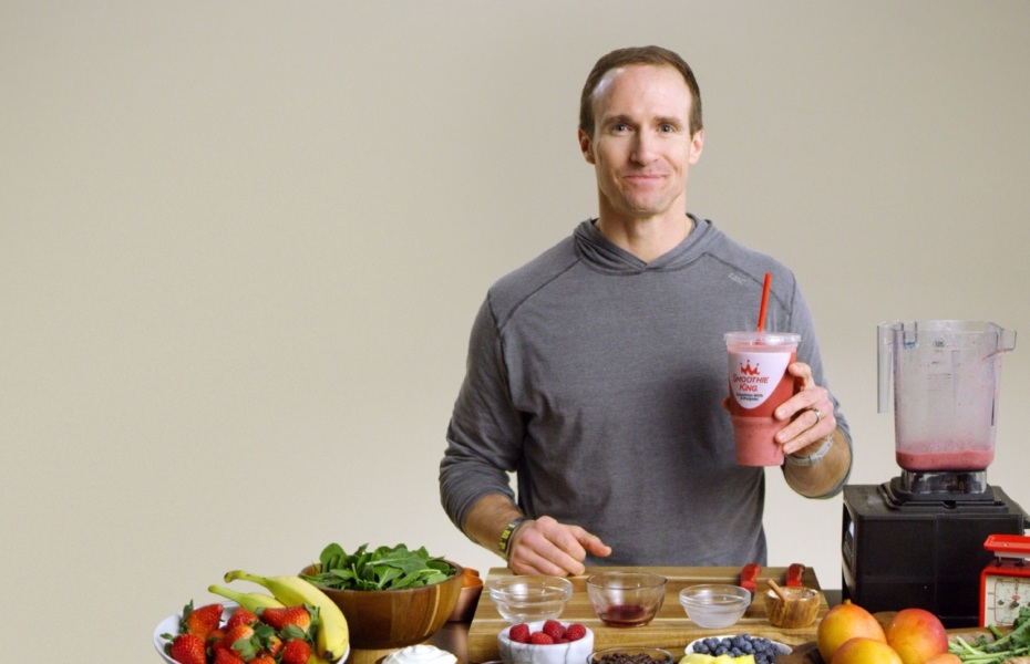 Drew Brees holding a smoothie that he made