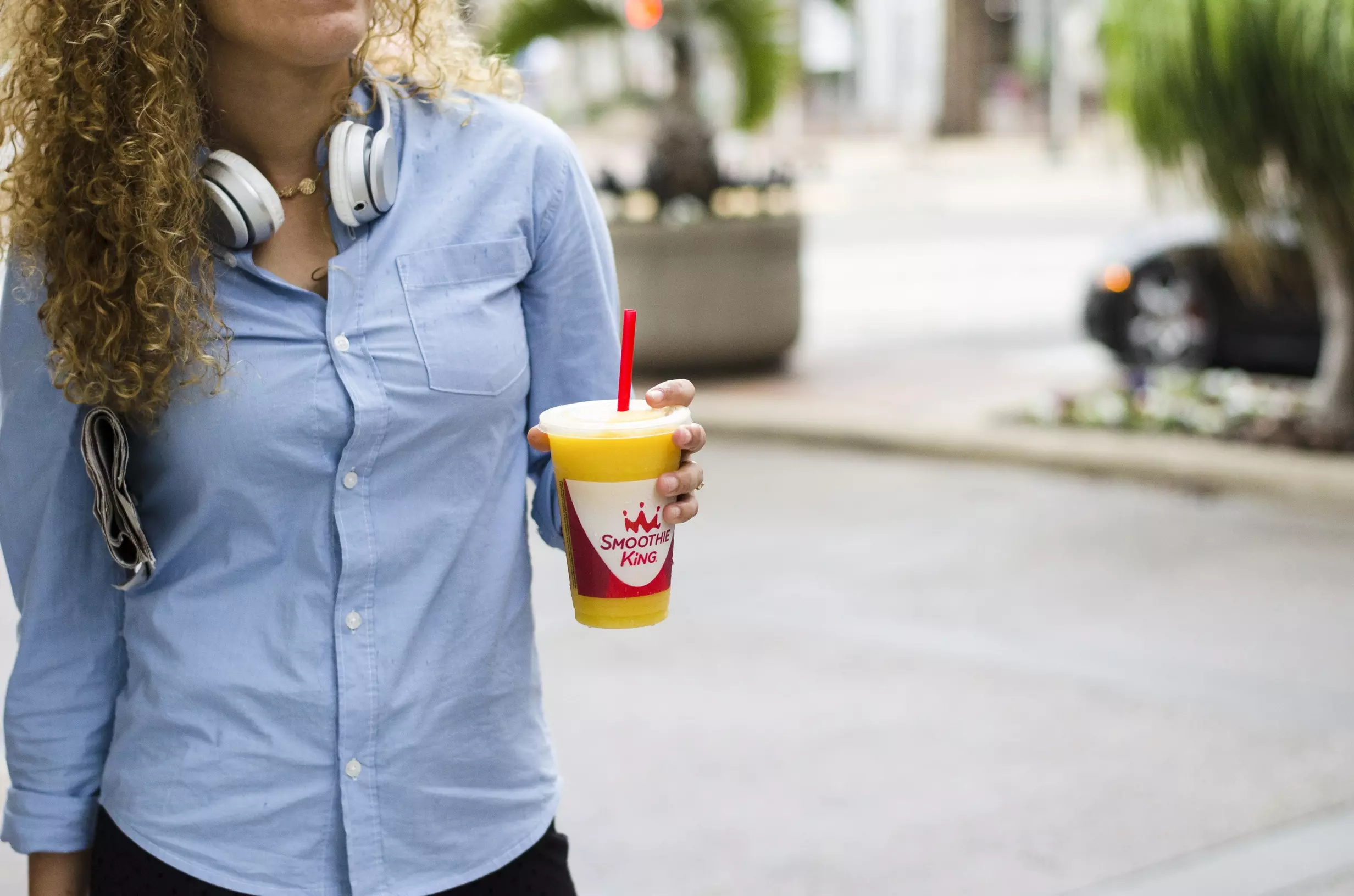 A woman enjoying Ozempic foods to eat with Smoothie King