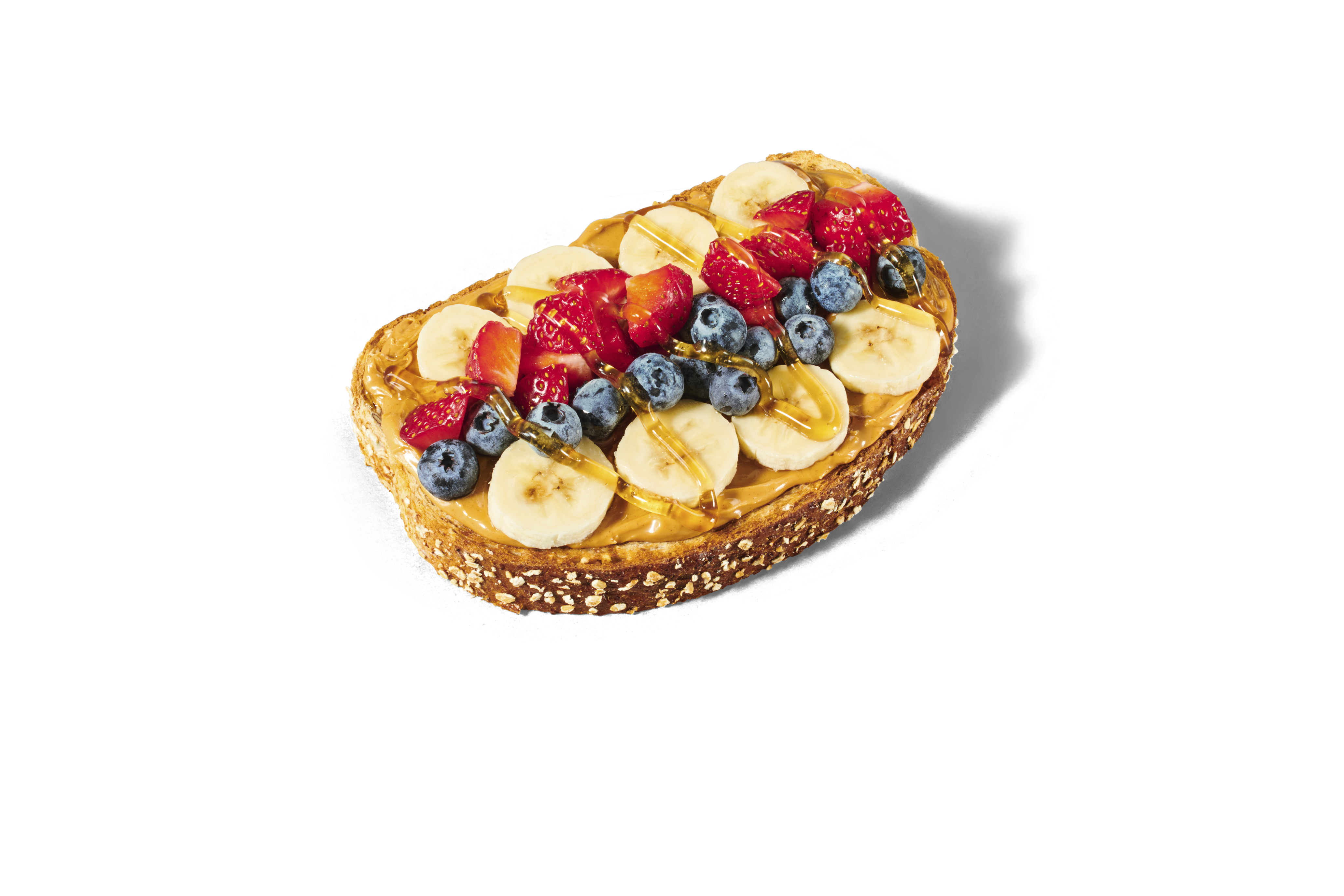 Loaded peanut butter toast topped with fruit and honey from Smoothie King
