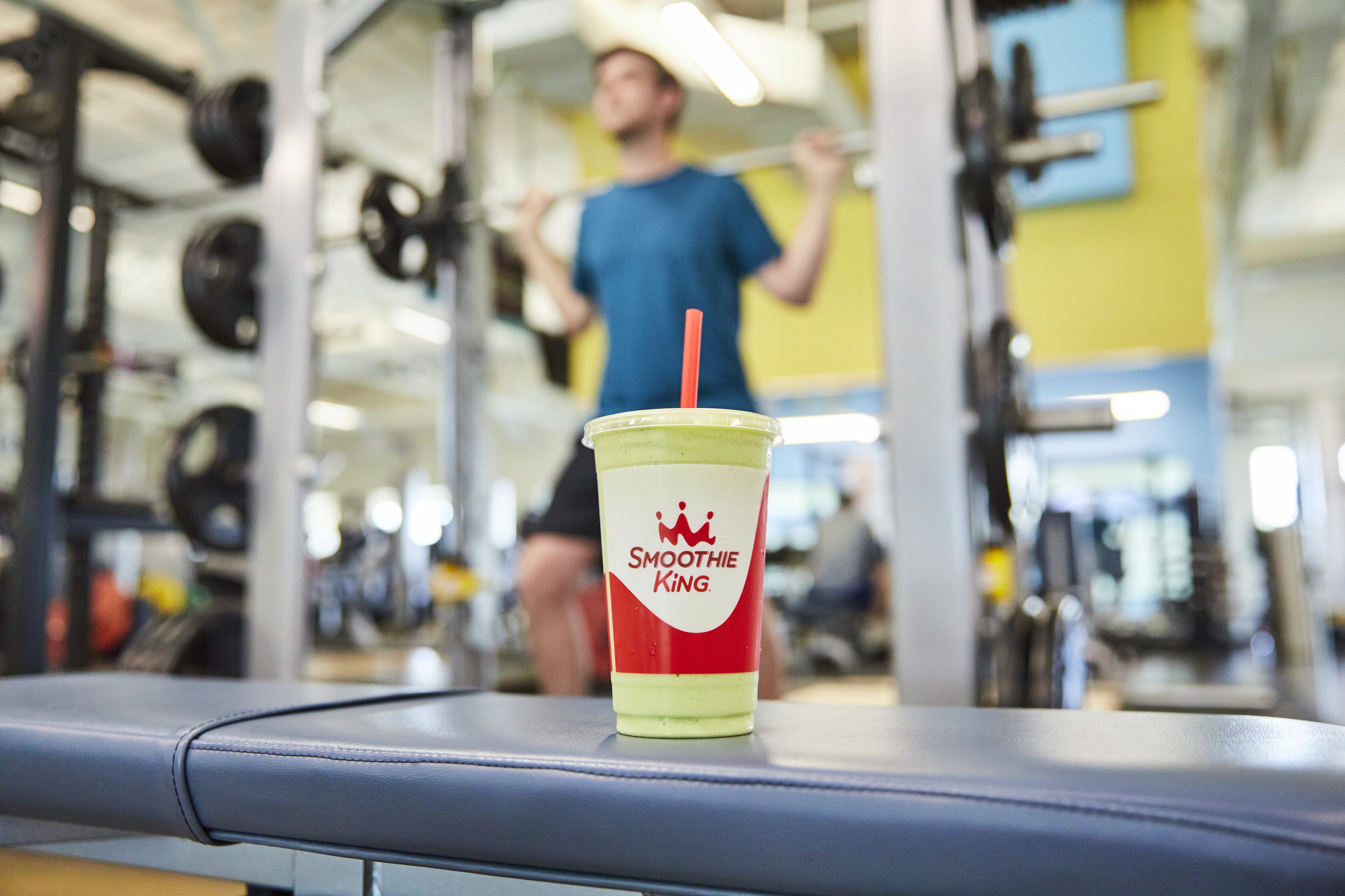 Someone going to the gym for a New Year's health goal, with a Smoothie King visible in the foreground