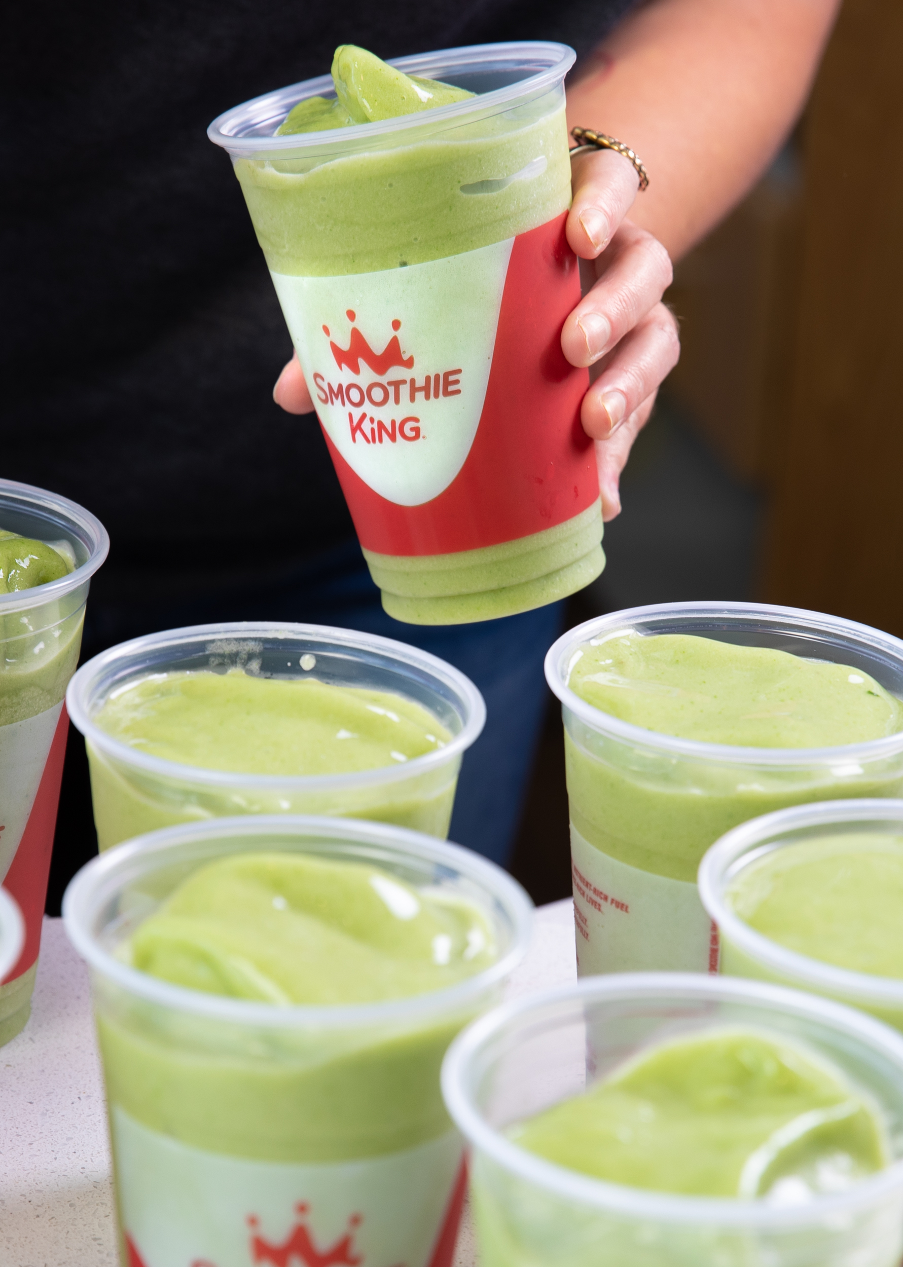 Multiple green veggie smoothies without lids from Smoothie King