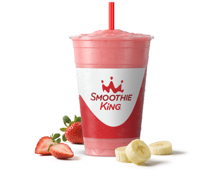 A pink strawberry banana smoothie in a Smoothie King cup with a red straw, part of Smoothie King history